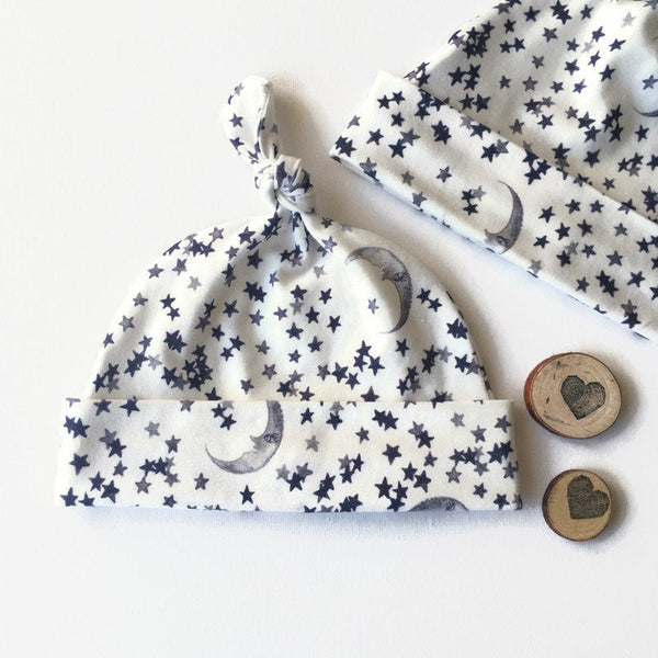 Baby muts van wolwitte tricot met sterren en manen