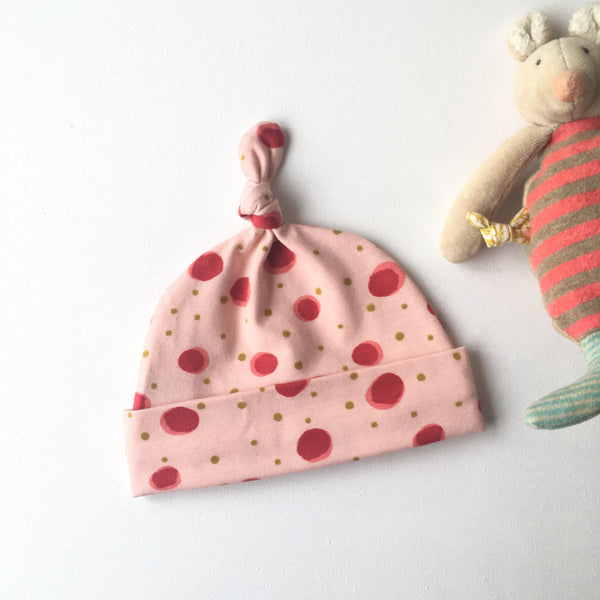 Roze baby muts met rode stippen