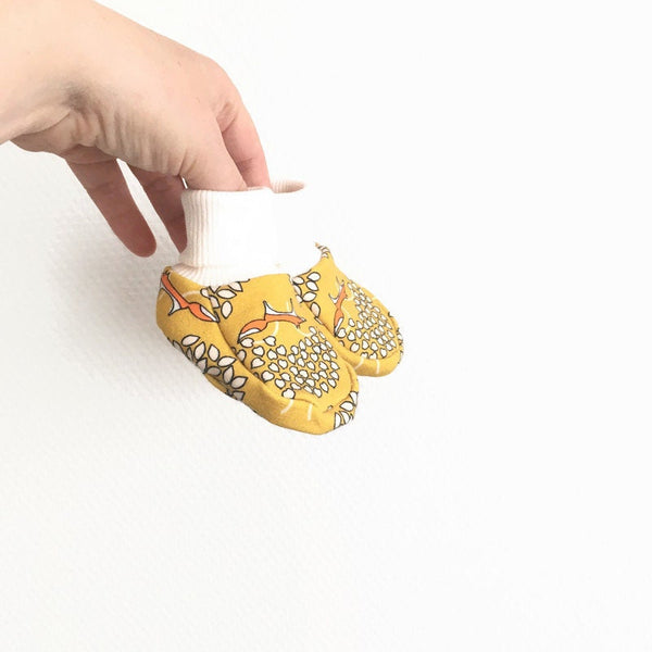 Gele baby slofjes met vossen.